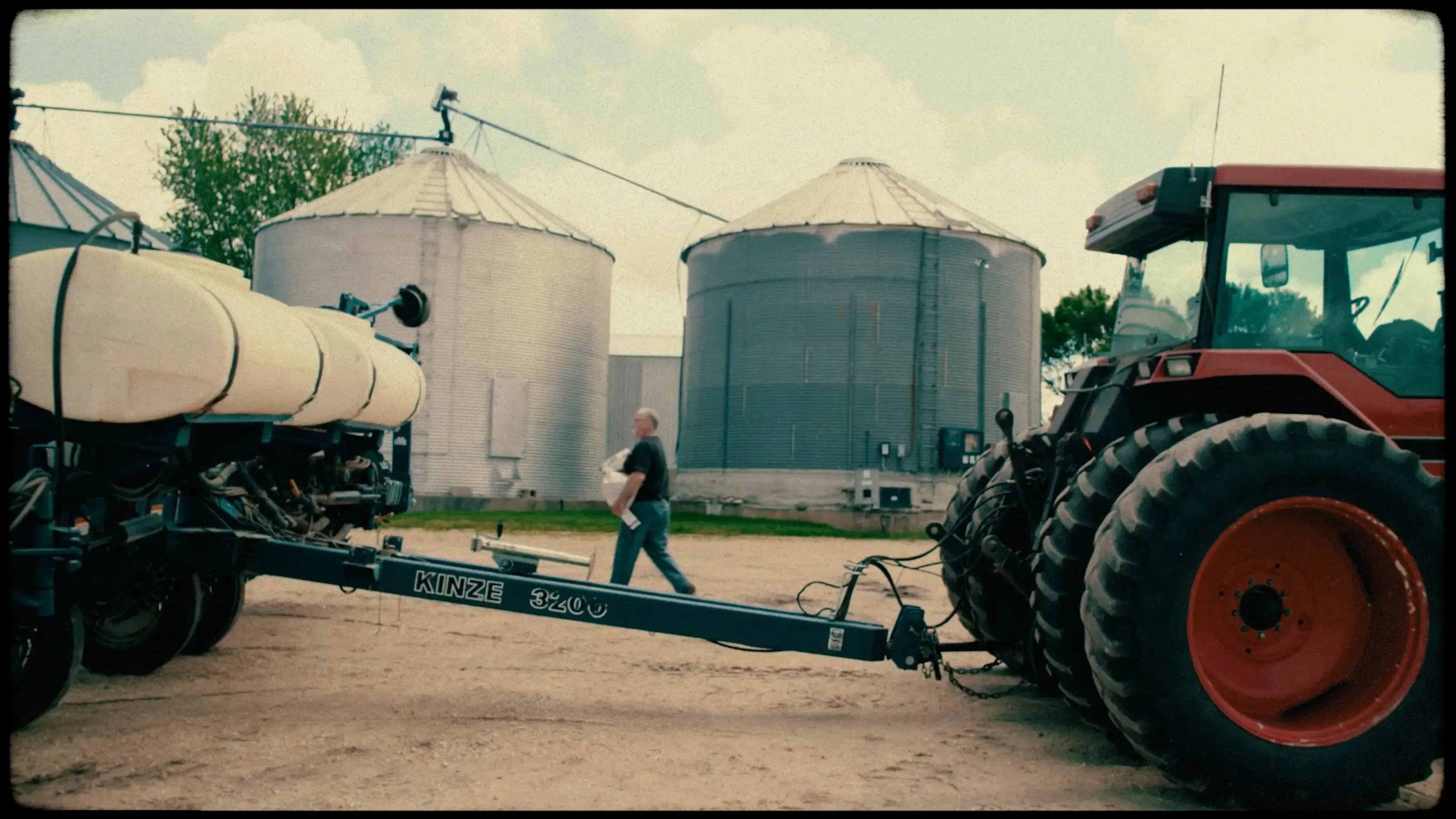 Man walking behind a tractor